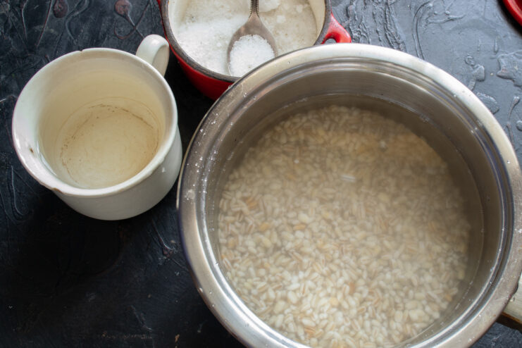 Preparing to cook Pearl barley in a pot with water and salt ready for boiling
