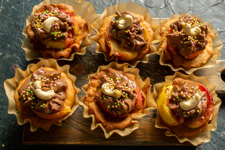 Dessert With Apples And Chocolate Cream Decorated apple tartlets with chocolate cream, cashews, and sprinkles on top