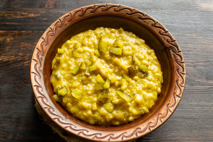 Plated pearl barley and lentil porridge in a rustic clay bowl