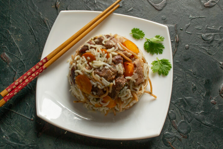 Serving The Dish Serving rice with vermicelli on a plate with chopsticks