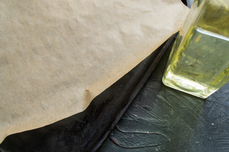 Preparing the baking paper Greasing parchment paper on a baking sheet with oil