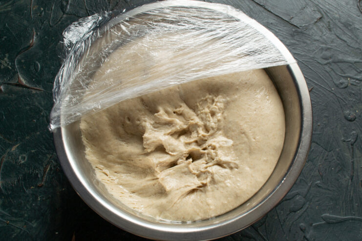 Risen sourdough in bowl Fluffy and airy risen sourdough inside a metal bowl
