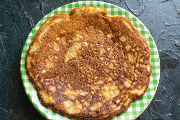 Ready oatmeal pancake Cooked golden oatmeal pancake resting on a checkered plate