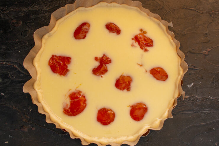Adding apricot halves Placing apricot halves cut-side down into the creamy filling