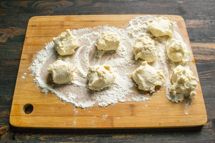 Portioning the dough Equal portions of dough dropped onto a flour-dusted cutting board