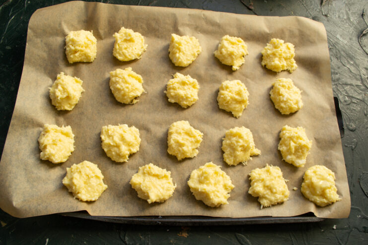 Shaping the cookies Small portions of cookie dough on a parchment-lined baking sheet