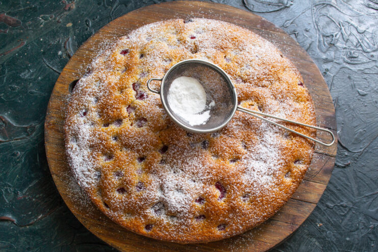 Dusting With Powdered Sugar Dusting the finished raspberry semolina cake with powdered sugar through a fine sieve