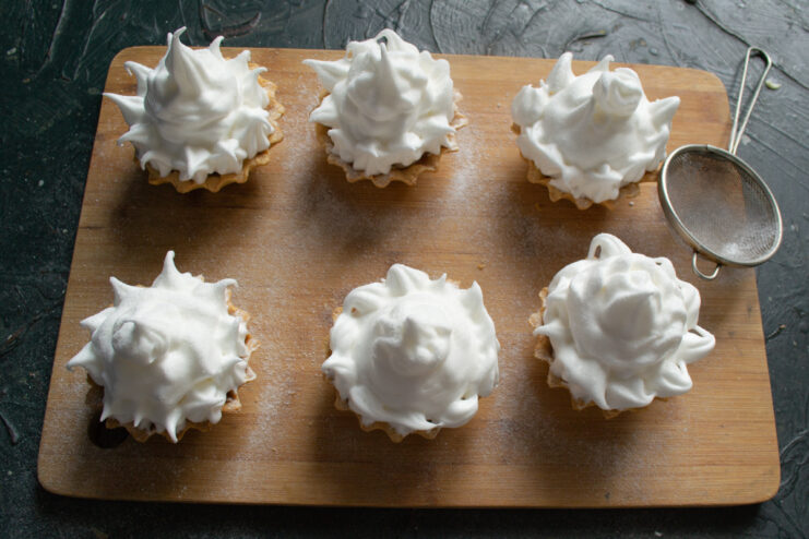 Dusting With Powdered Sugar Dusting tartlets with powdered sugar using a fine-mesh strainer