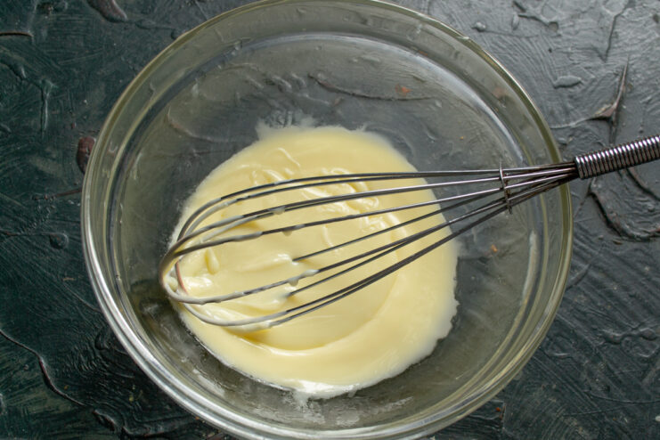 Whipping the Buttercream Whisking softened butter and condensed milk into a fluffy cream