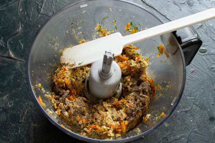Blending pate ingredients Blending the chicken pate mixture in a food processor with a spatula