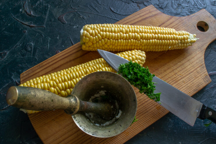 Making the aromatic dressing Crushing fresh parsley, garlic, and coarse salt in a mortar