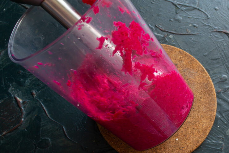Blending for a finer texture Blending the horseradish and beet sauce with an immersion blender to achieve a finer texture.