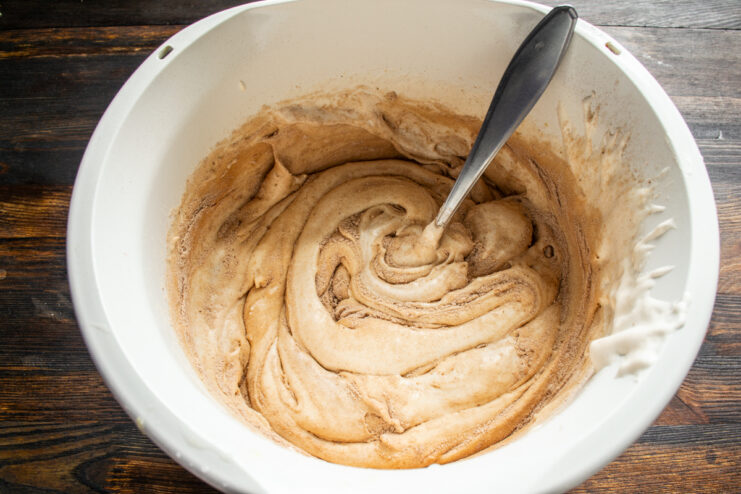Folding the chocolate batter Folding the chocolate sponge batter gently with a spoon.