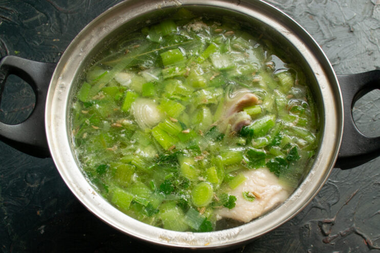 Simmering the broth Chicken broth with herbs simmering gently on the stove