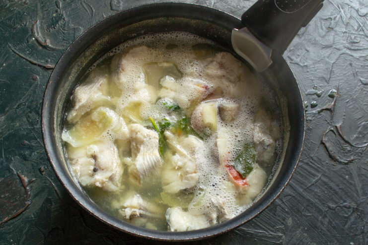 Simmering the Fish Broth Fish broth simmering in a saucepan