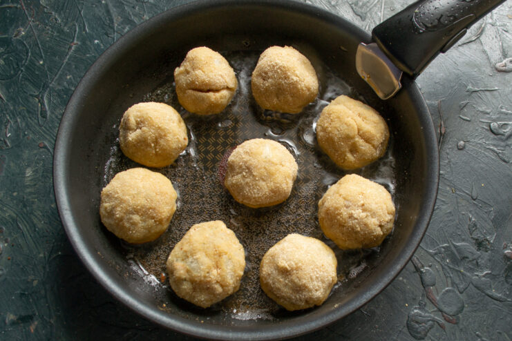 Frying the Fishballs Frying breaded fishballs in hot oil in a heavy skillet.