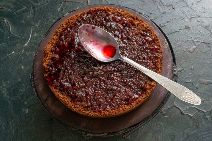 Soaking the Layers Soaking a chocolate cake layer with raspberry syrup