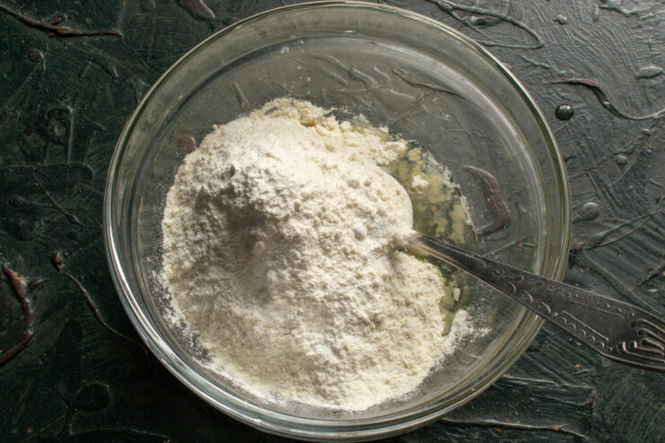 Adding Flour Sifting flour and baking powder into the fat and oil mixture
