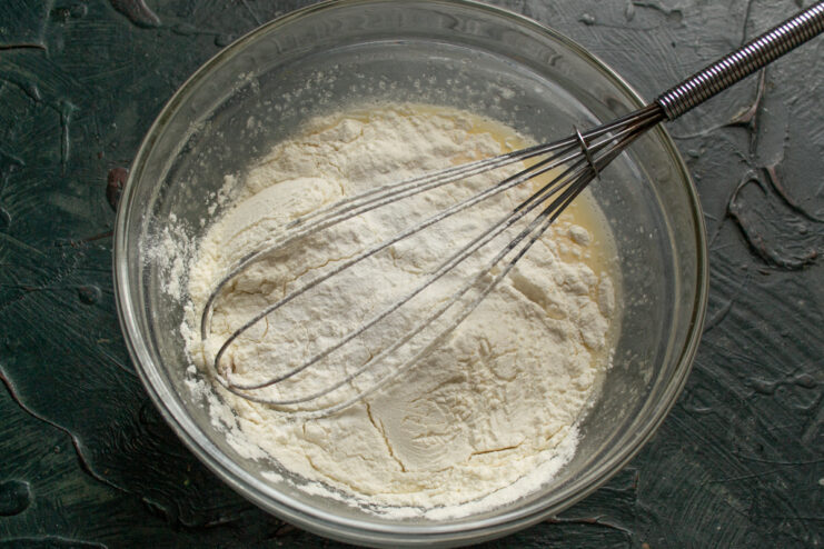 Folding in Dry Ingredients Sifting all-purpose flour and baking powder into the wet mixture
