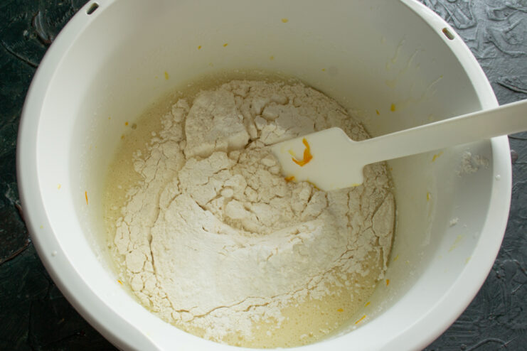 Adding the flour Sifting flour into the bowl with wet ingredients