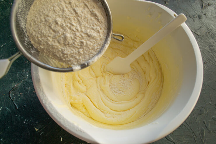 Folding Flour Into The Batter Sifting flour into whipped egg mixture through a mesh sieve