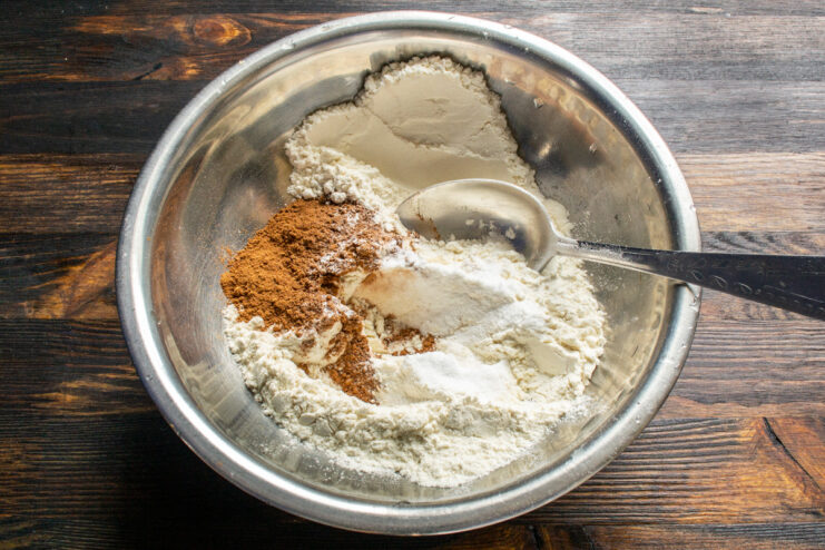 Mixing the dry ingredients Cake flour, cocoa, cinnamon, and baking powder in a metal bowl.