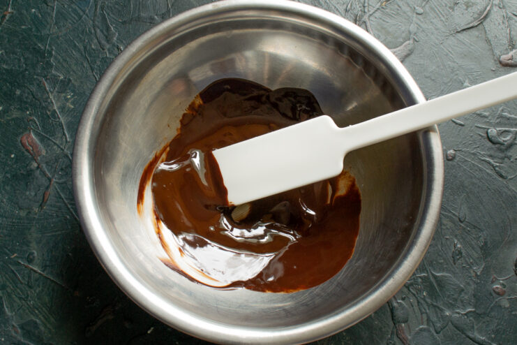 Melting the chocolate Melted dark chocolate in a metal bowl