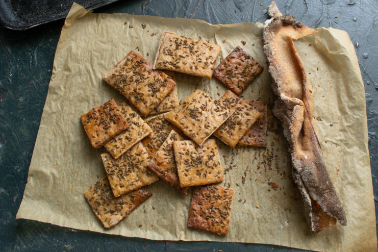 Snapping into portions Breaking a large sheet of baked crispbread into squares along score lines