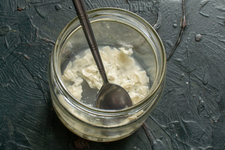 Soaking starter particles Rehydrated sourdough starter mixed with water in a glass jar