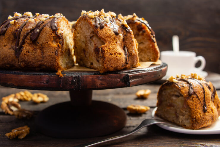 Cross-section of an apple fruit cake with chocolate glaze and walnuts