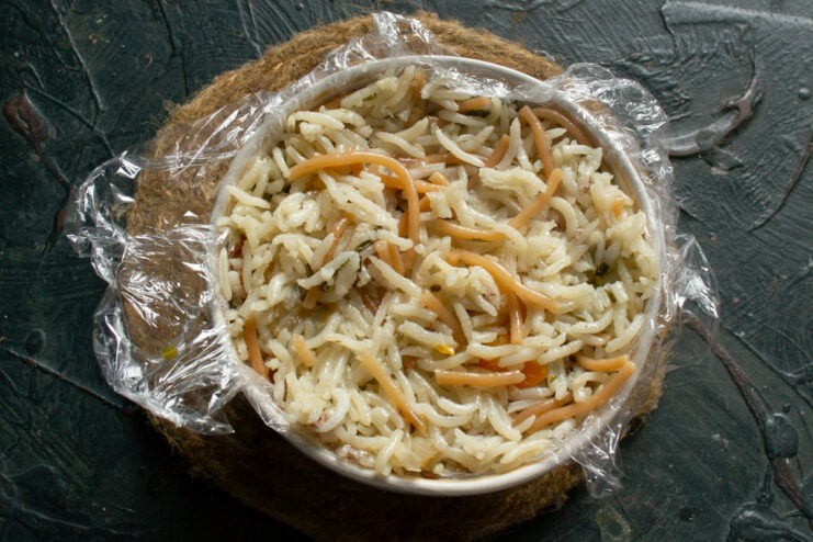 Molding A Portion Rice packed in a mold with plastic wrap