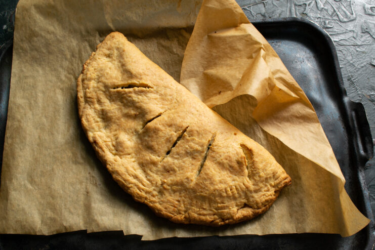 Freshly Baked Pie Golden brown baked pie resting on a baking sheet