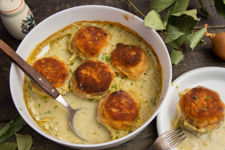 Fish meatballs with vegetables baked in a creamy sauce