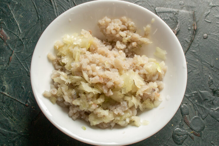 Making the Fish Mince Base Minced fish passed through a meat grinder together with onions.