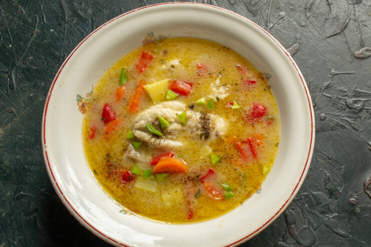 Serving the cod soup Plating fish soup in a deep bowl with black pepper garnish
