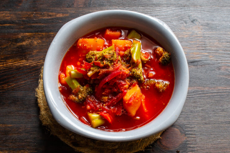 Serving the finished borscht Top view of vegetarian borscht with broccoli in a bowl
