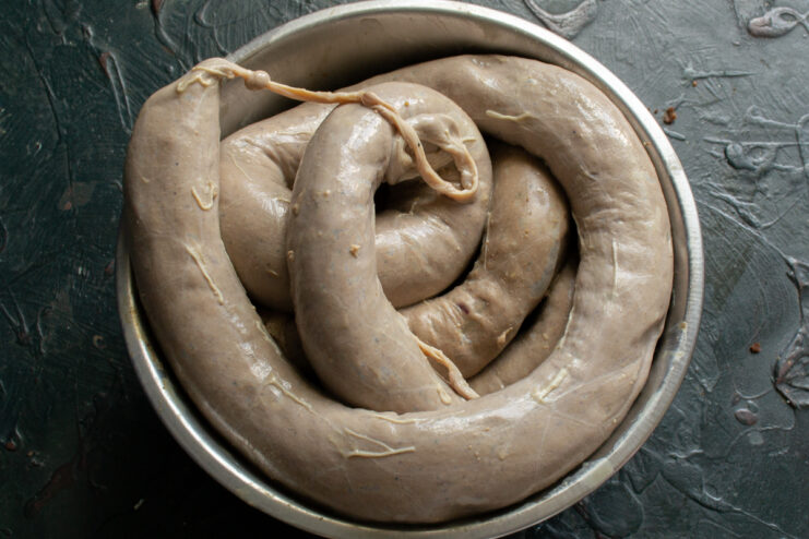 Stuffing The Sausage Formed rings of raw chicken liver sausage in a bowl