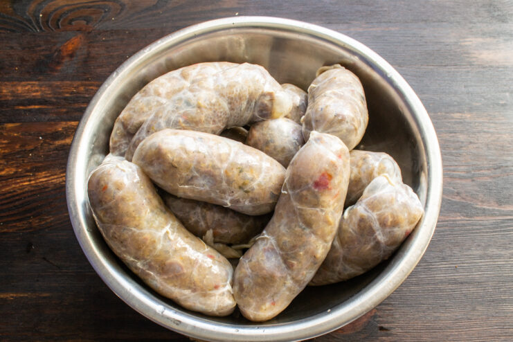 Stuffing the sausages Raw stuffed chicken sausages shaped into links