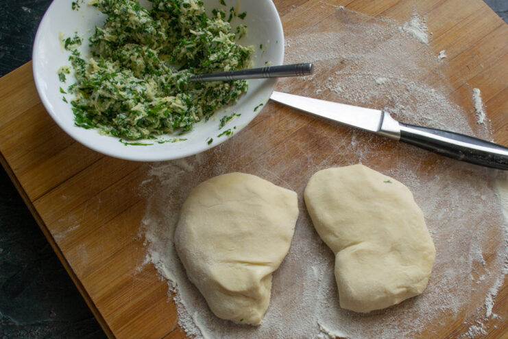 Forming Dough Balls Balls of dough and filling on a wooden cutting board