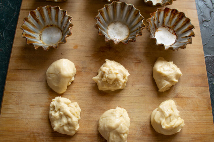 Dividing Dough Into Equal Parts Six equal portions of pastry dough placed on a cutting board