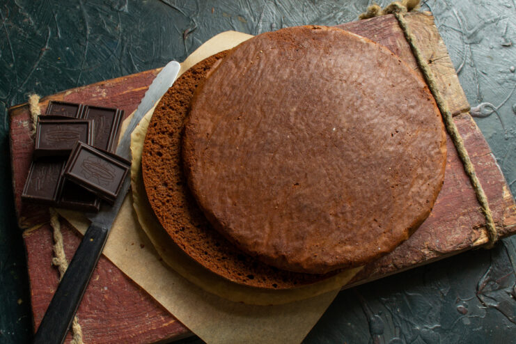 Sponge cake texture Sliced chocolate genoise sponge cake revealing its porous crumb on a wooden surface