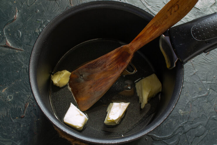 Melting vegetable oil and butter Melting butter and vegetable oil in a small saucepan over heat