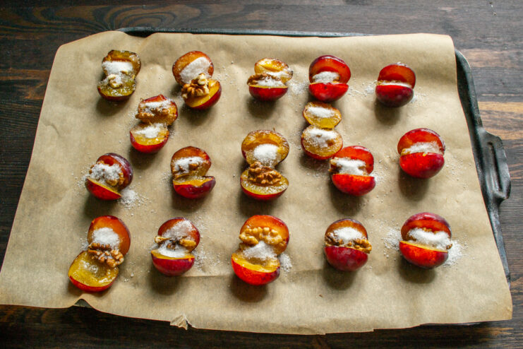 Stuffed plums lightly sprinkled with granulated sugar ready for baking