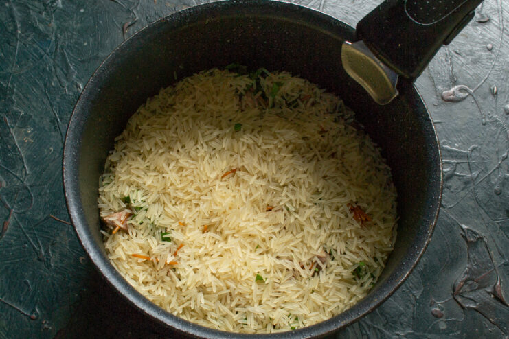 Layering Rice Layer of basmati rice over ingredients