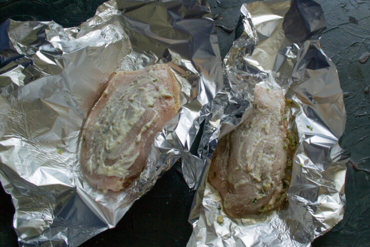 Brushing the chicken with mayonnaise Top of the stuffed chicken breast brushed with a thin layer of mayonnaise before baking.