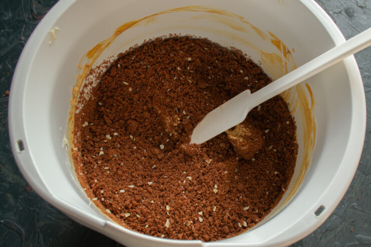 Mixing sponge cake crumbs with buttercream.
