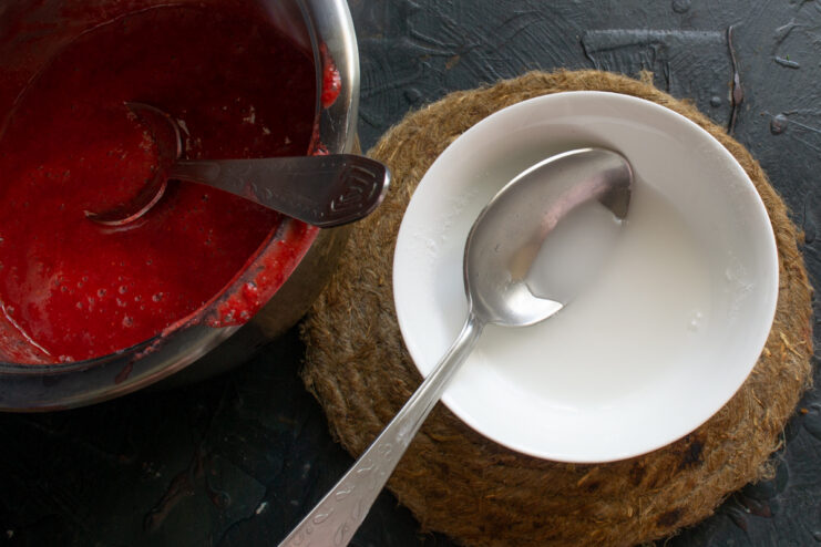 Preparing the thickener Mixing potato starch with cold water in a small bowl