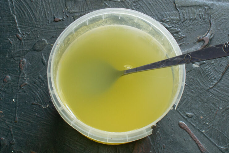 Preparing wet ingredients Whisking honey and whey together in a mixing bowl