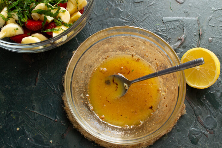 Whisking The Balsamic Dressing Stirring drops of balsamic vinegar into the honey citrus dressing