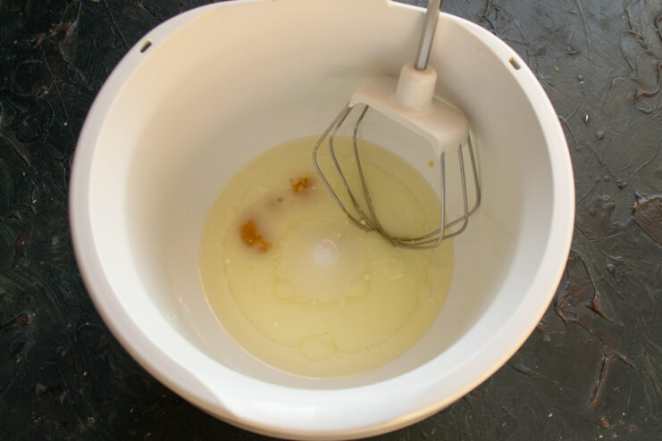 Mixing milk, vegetable oil, and honey in a bowl